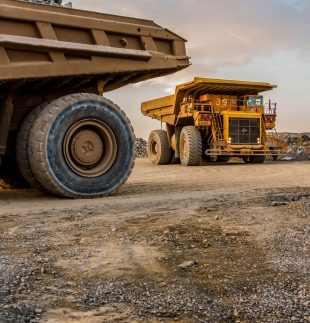 A vertical shot of dump trucks transporting Platinum ore for processing